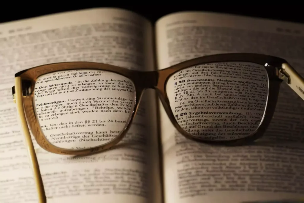 glasses placed on top of an open book