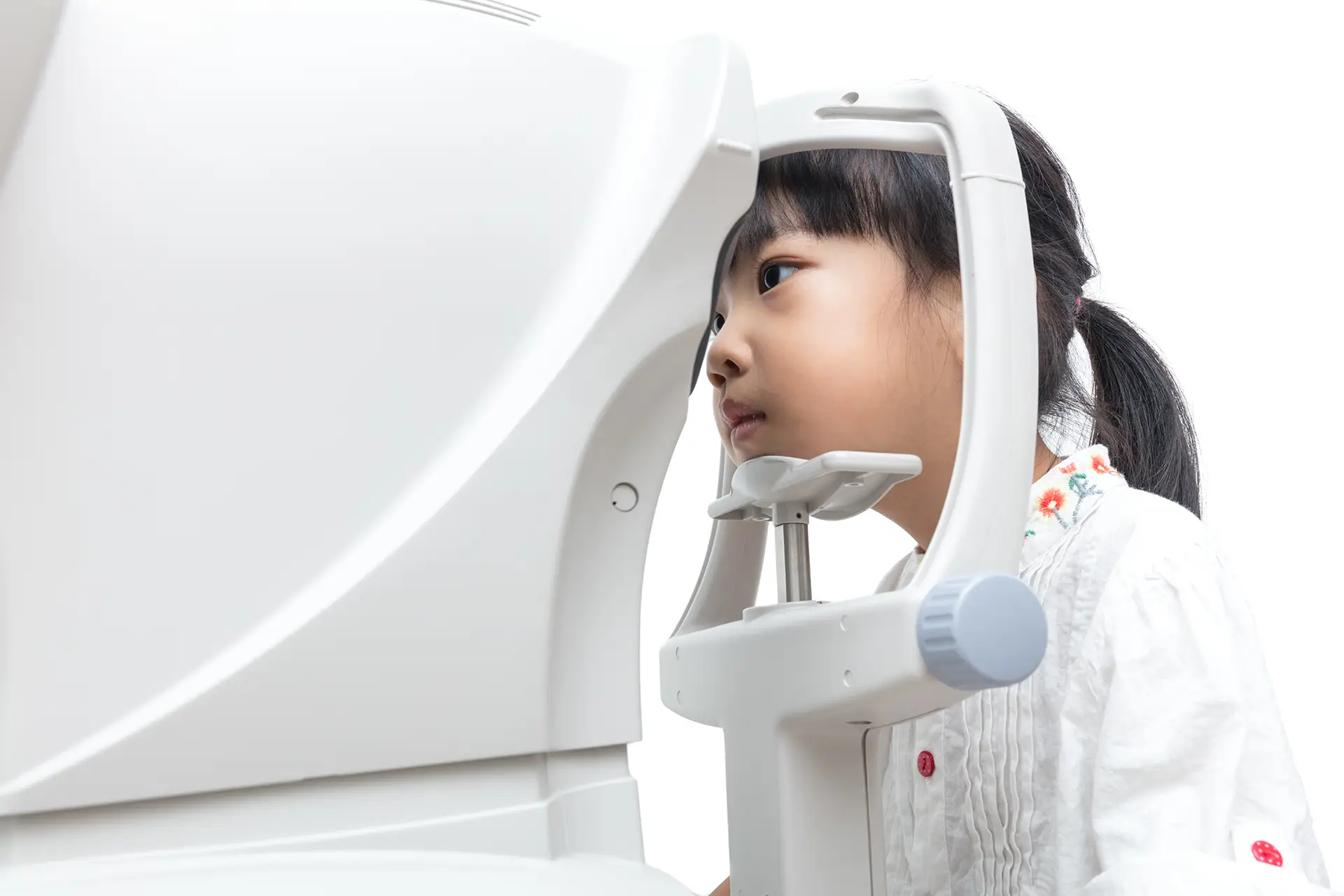 Young child being given an eye exam for mypia control from an optometrist.